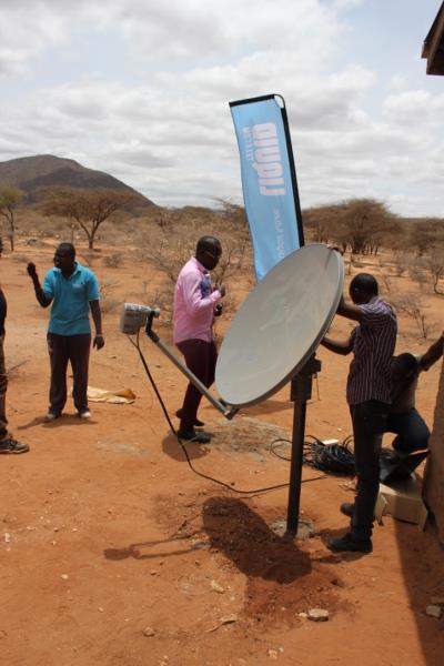 Engineers install Liquid Telecoms' "most robust" VSAT dish on a metre high pole in the Kenyan village of Kiltamany. 
